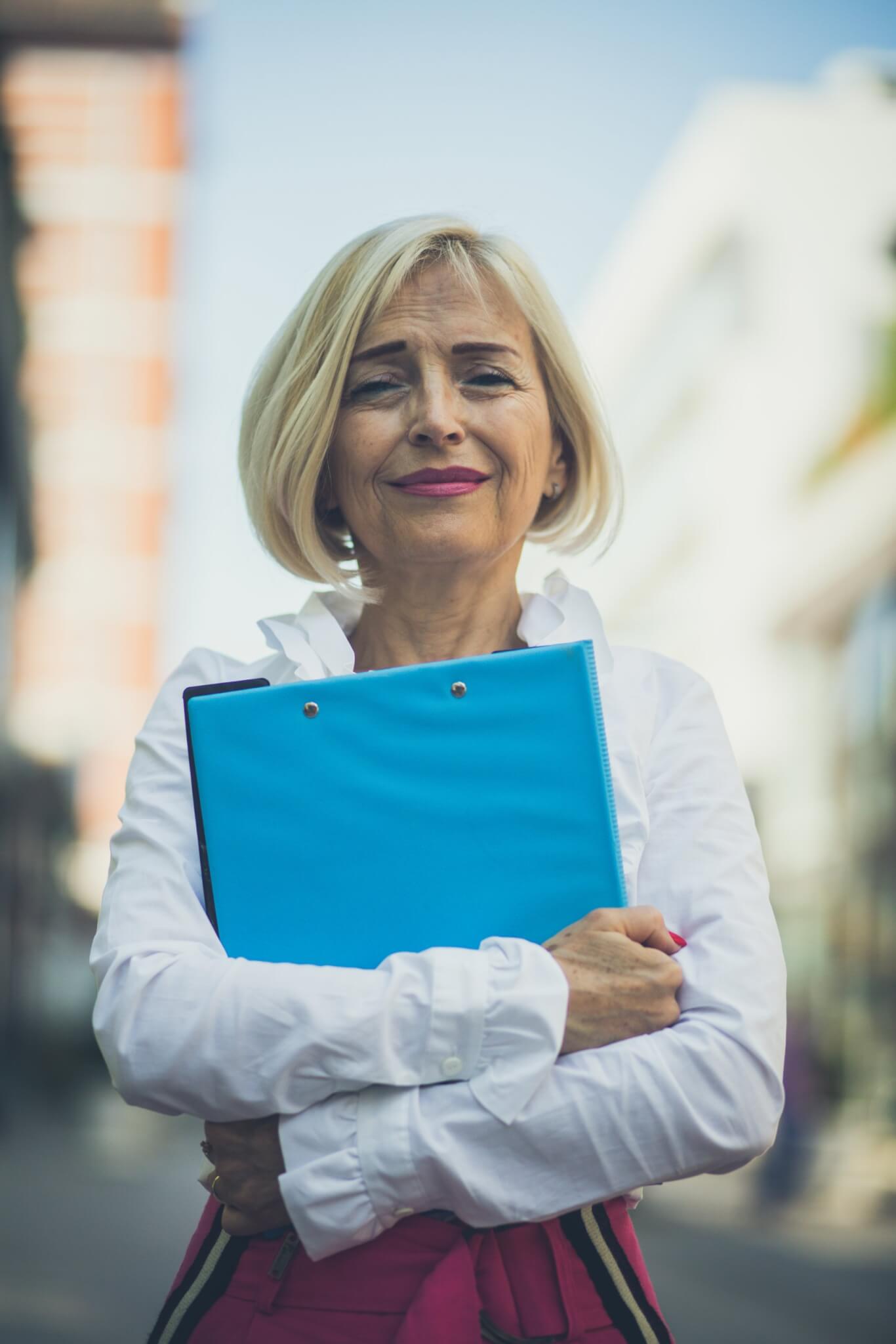 Woman holding binder, planning retirement